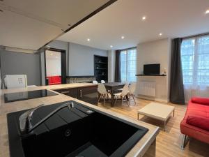 un salon avec un canapé rouge et une table dans l'établissement Au coeur de Cauterets, T2 + alcôve. 4P., à Cauterets