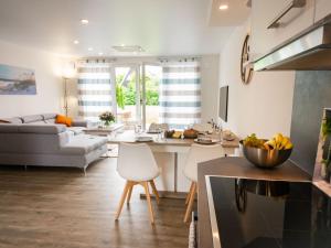 une cuisine et un salon avec une table et des chaises dans l'établissement Ferienhaus in Damp am Ostseestrand, à Damp