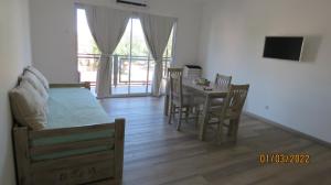 a bedroom with a bed and a table and chairs at Aguas Calmas in Carhué