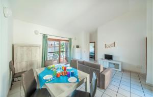 a dining room with a blue table and chairs at Trilo Sup in Isola Rossa
