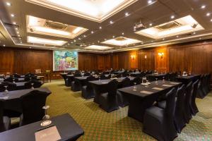a conference room with tables and chairs and a screen at Park Plaza Santiago in Santiago