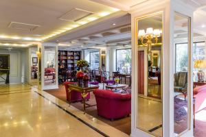 a lobby with red chairs and tables in a building at Park Plaza Santiago in Santiago
