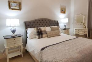 a bedroom with a large bed with two night stands at Fleurie Guest House in Torquay