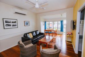 a living room with a couch and a table at Kooyong Apartment 2 in Arcadia