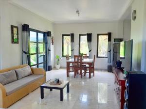 a living room with a couch and a table at Medewi Manor in Pulukan