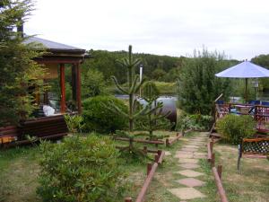 a garden with a cactus and a table and chairs at Rio Maullin Lodge in Puerto Varas