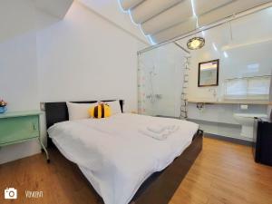 una camera da letto con un letto grande in una stanza di Honey House Tainan a Tainan