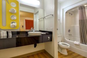 
a bathroom with a toilet, sink, and shower at Motel 6-San Dimas, CA - Los Angeles in San Dimas
