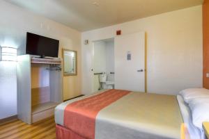 a hotel room with a bed and a flat screen tv at Motel 6-San Dimas, CA - Los Angeles in San Dimas
