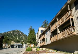 a building with balconies on the side of a street at Spacious One Bedroom Condo in Mammoth! Free Assigned Parking - Snowbird 107 in Mammoth Lakes