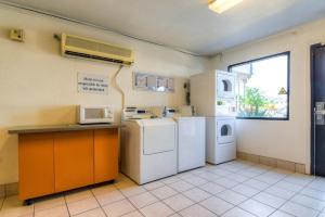 a laundry room with white appliances and a window at Motel 6-El Cajon, CA - San Diego in El Cajon