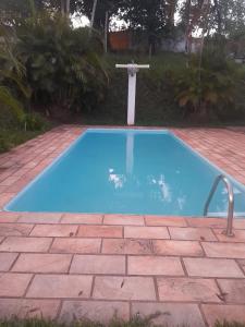 a small blue swimming pool on a brick patio at Recanto da Natureza in Serra Negra