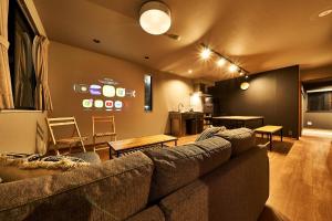 a living room with a couch and a kitchen at Rakuten STAY HOUSE Kisarazu in Kisarazu