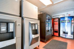 a gas station with a dassault machine and a ticket machine at Motel 6-Pomona, CA - Los Angeles in Pomona