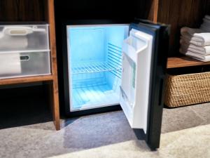 an empty refrigerator with its door open in a room at Rakuten STAY Naha-Miebashi Twin Room in Naha