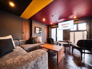 a living room with a couch and a tv at Rakuten STAY x EAGLES 102 with terrace in Sendai