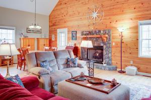 a living room with a couch and a fireplace at Deer Hollow in Ellijay
