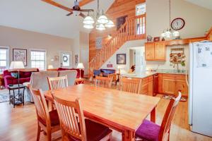 a kitchen and dining room with a wooden table and chairs at Deer Hollow in Ellijay