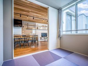 a dining room with a table and a large window at Rakuten STAY HOUSE x WILL STYLE Takasaki 102 in Takasaki