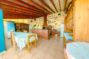 ein Esszimmer mit einem Tisch und einer Küche in der Unterkunft Pousada Recanto da Vó Ziza in Brotas
