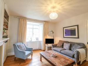 a living room with a couch and a table at Brock Cottage in Bridport