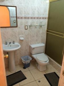 a bathroom with a toilet and a sink at Posada Don Giorgio in Puno +46 photos