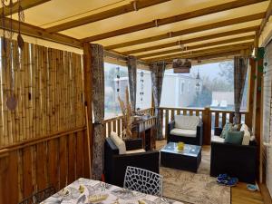 a screened in porch with two chairs and a table at Mobil Home -LES Flamants Roses MAR ESTANG in Canet-en-Roussillon