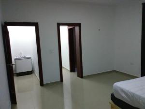 a room with three doors and a bed in it at Bright Apartment at Punta Cana WIFIAcElectIronParking in Punta Cana