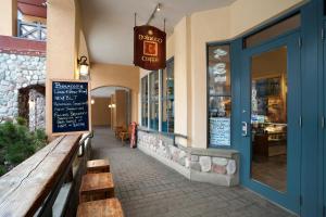 a restaurant with a bench in front of a building at Sundance Lodge in Sun Peaks