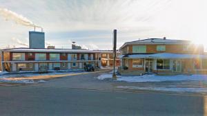 an empty street in front of a building at Chalet Inn Motel in Dryden