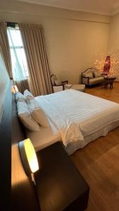 a bedroom with a large white bed in a room at Tanjung Villa in Muar