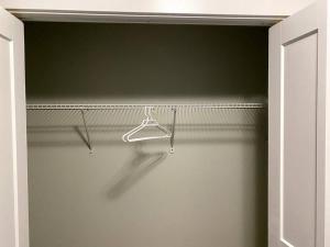an empty closet with a hanger in a room at Beautiful and Spacious 1 room in a very quiet area in Airdrie