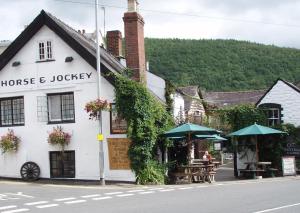 
a large brick building with a clock on the side of it at The Horse & Jockey Inn in Knighton
