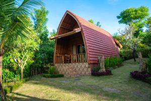 a small house with a red roof at Ring Sun Cottages in Uluwatu