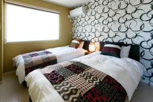Een bed of bedden in een kamer bij Libre Hosai Stay Kanazawa - Vacation STAY 3359