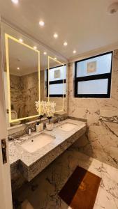a bathroom with a sink and a large mirror at Sodic Westown Residence 2 in 6th Of October