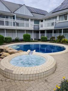 a swimming pool in a circle in front of a building at Dalby Manor Motor Inn in Dalby