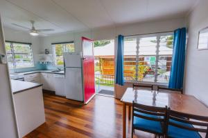 a kitchen with a table and a refrigerator at Kooyong Apartment 7 in Arcadia