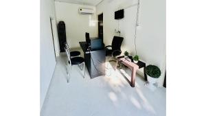 a room with a desk with chairs and a computer at Hostel ivory in Jaipur