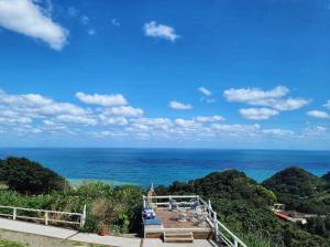 a view of the ocean from a house at A Promised Land BnB in Jiufen