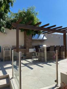 a patio with a wooden pergola and a table at Casa Islas in Puerto Peñasco