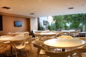 a room with tables and chairs and a tv at Club Campestre De Bucaramanga in Bucaramanga
