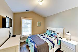a bedroom with a bed and a tv and a window at Kashton Charms in Myrtle Beach