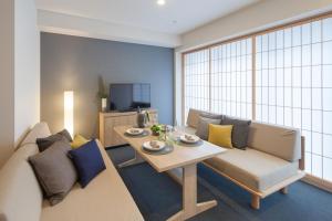a living room with a couch and a table at MIMARU TOKYO AKASAKA in Tokyo