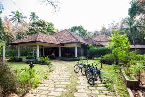 a house with bikes parked in front of it at Vaikundam Legacy in Kaliyal