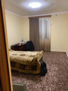 a hotel room with a bed and a desk at Friend's House rooms near Airport in Yerevan