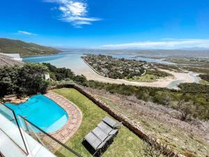 an overhead view of a swimming pool and a beach at The White House in Knysna