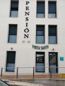 a building with the sign for the portico santana at PENSION PORTA SANTA in Baleira