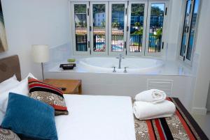 a bedroom with a large window and a large bed at Beachside Magnetic Harbour Apartments in Nelly Bay