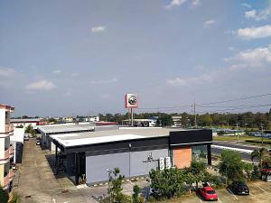 a building with a krispy kreme sign on top of it at โรงแรมวิจิตรพร อุบล VJP Hotel Ubon in Ubon Ratchathani